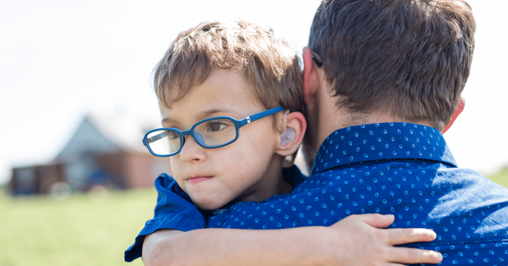 Boy hugging his dad. How does  family-centered services make a difference